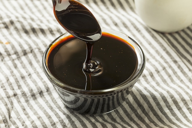 molasses flowing from a spoon into a bowl